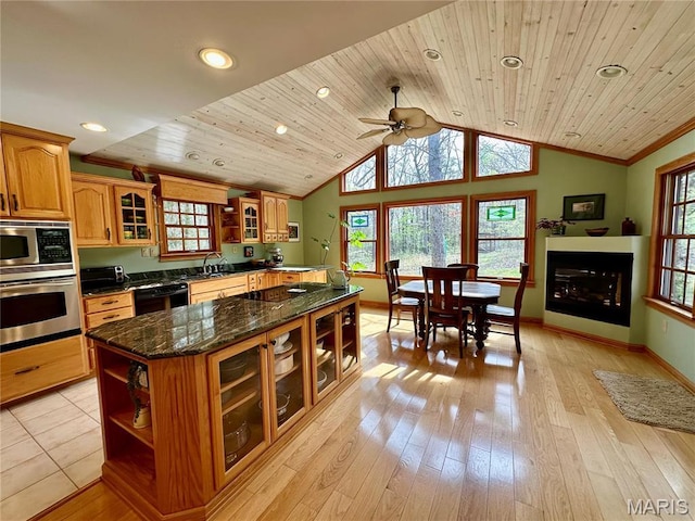 15716 County Road 5190, Rolla, MO 65401 - kitchen with black appliances, a sink, healthy amount of natural light, brown cabinetry, and vaulted ceiling