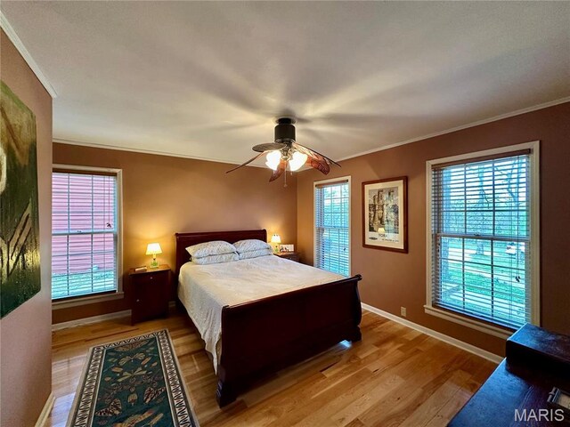 15716 County Road 5190, Rolla, MO 65401 - bedroom featuring wood finished floors, crown molding, baseboards, and ceiling fan