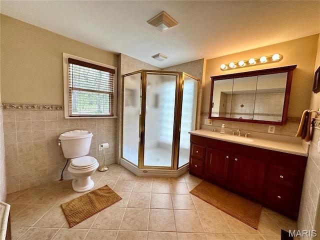15716 County Road 5190, Rolla, MO 65401 - bathroom with tile walls, tile patterned floors, a stall shower, vanity, and toilet