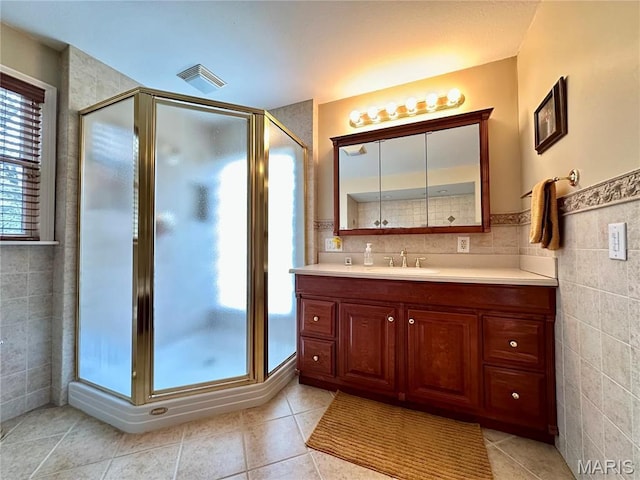 15716 County Road 5190, Rolla, MO 65401 - bathroom featuring a stall shower, vanity, tile patterned flooring, and tile walls