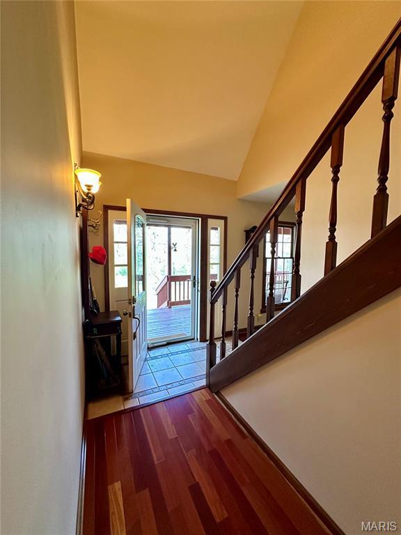 15716 County Road 5190, Rolla, MO 65401 - entrance foyer with dark wood-style floors, stairway, and vaulted ceiling