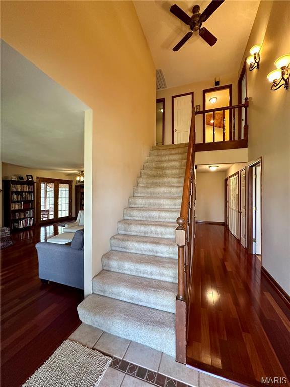 15716 County Road 5190, Rolla, MO 65401 - staircase featuring ceiling fan, wood finished floors, and high vaulted ceiling