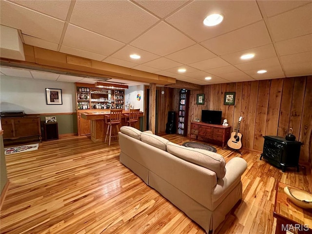 15716 County Road 5190, Rolla, MO 65401 - living room with a drop ceiling, bar, light wood-type flooring, a wood stove, and baseboards
