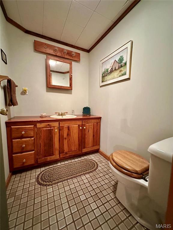 15716 County Road 5190, Rolla, MO 65401 - half bathroom with crown molding, toilet, baseboards, and vanity
