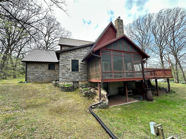 15716 County Road 5190, Rolla, MO 65401 - rear view of property with stone siding, a sunroom, a chimney, a lawn, and a wooden deck