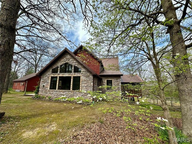 15716 County Road 5190, Rolla, MO 65401 - rear view of house with stone siding, metal roof, and a lawn