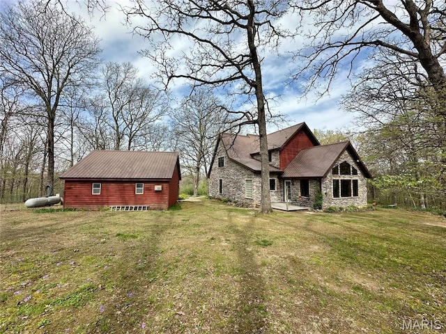 15716 County Road 5190, Rolla, MO 65401 - back of house with stone siding, metal roof, and a yard