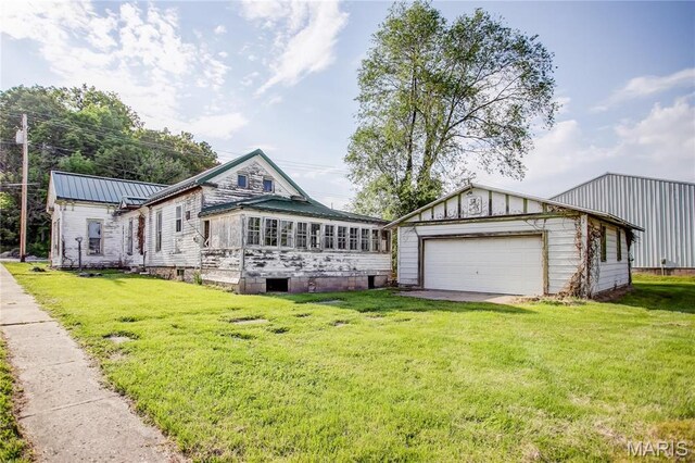212 Franklin St, Hardin, IL 62047 - view of front of house with an outbuilding, a garage, a front yard, and metal roof