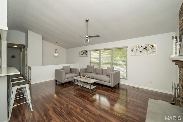 101 Holly Green Dr, Ballwin, MO 63021 - living area featuring baseboards, a ceiling fan, vaulted ceiling, a fireplace, and wood finished floors