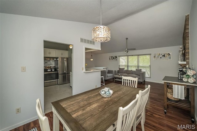 101 Holly Green Dr, Ballwin, MO 63021 - dining area with ceiling fan, lofted ceiling, baseboards, a textured ceiling, and dark wood-type flooring