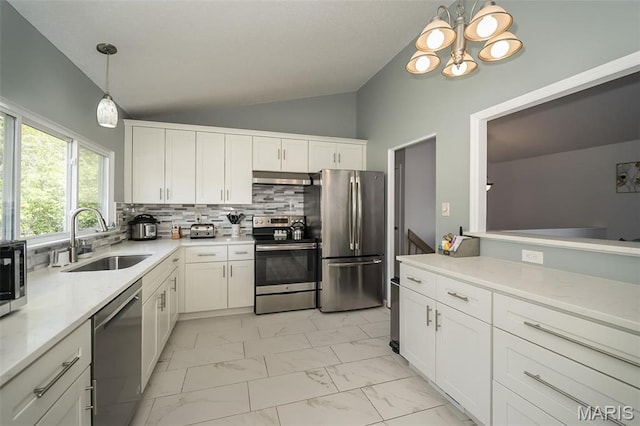 101 Holly Green Dr, Ballwin, MO 63021 - kitchen with stainless steel appliances, lofted ceiling, a sink, light marble finish floors, and decorative backsplash