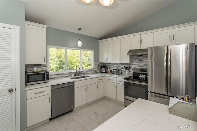 101 Holly Green Dr, Ballwin, MO 63021 - kitchen featuring appliances with stainless steel finishes, a sink, light marble finish flooring, under cabinet range hood, and lofted ceiling