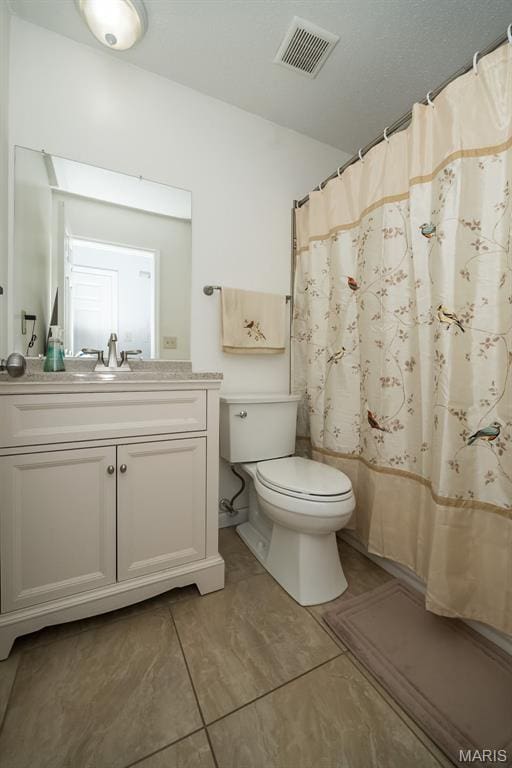 101 Holly Green Dr, Ballwin, MO 63021 - bathroom featuring toilet, vanity, a shower with curtain, and tile patterned floors