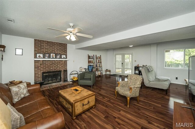 101 Holly Green Dr, Ballwin, MO 63021 - living area with a textured ceiling, wood finished floors, ceiling fan, a brick fireplace, and plenty of natural light