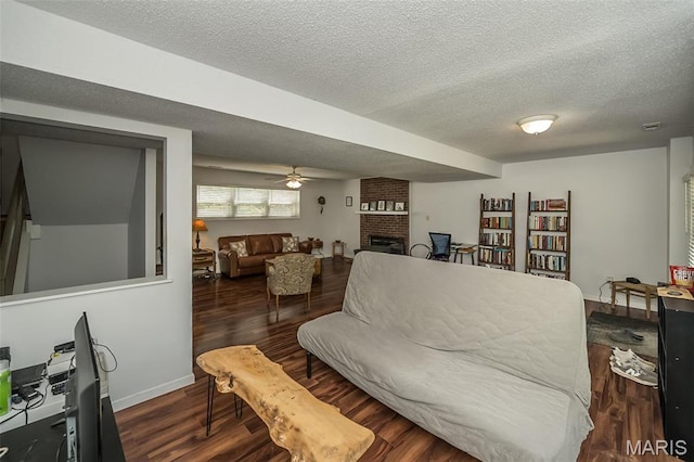 101 Holly Green Dr, Ballwin, MO 63021 - living area featuring a fireplace, a textured ceiling, wood finished floors, ceiling fan, and baseboards