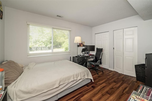 101 Holly Green Dr, Ballwin, MO 63021 - bedroom featuring dark wood finished floors, multiple closets, and a desk