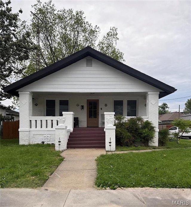 305 W Ray St, Christopher, IL 62822 - view of front of home featuring a porch and brick siding