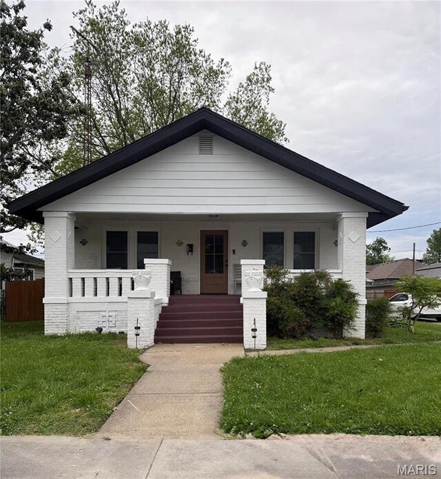 305 W Ray St, Christopher, IL 62822 - view of front of house featuring a porch and brick siding