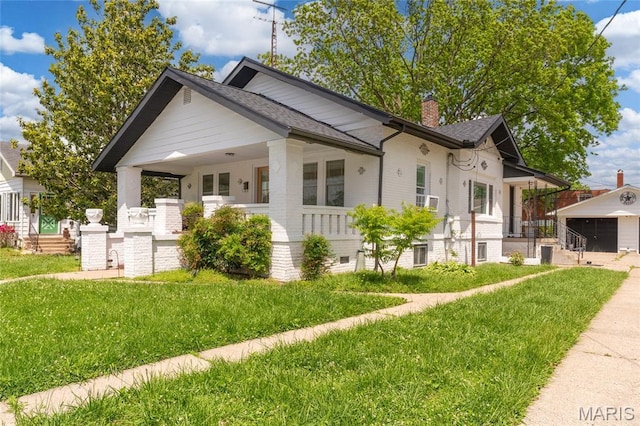 305 W Ray St, Christopher, IL 62822 - view of front of house featuring a front yard, a chimney, covered porch, and roof with shingles