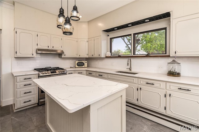 305 W Ray St, Christopher, IL 62822 - kitchen featuring stainless steel gas range oven, a sink, under cabinet range hood, decorative backsplash, and dark marble finish floors