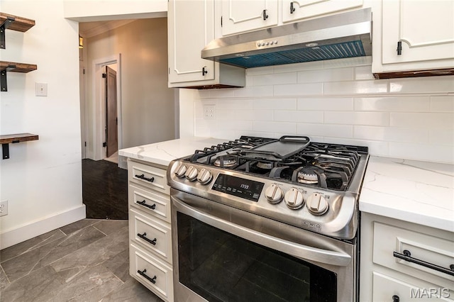 305 W Ray St, Christopher, IL 62822 - kitchen featuring gas range, under cabinet range hood, backsplash, baseboards, and dark marble finish flooring