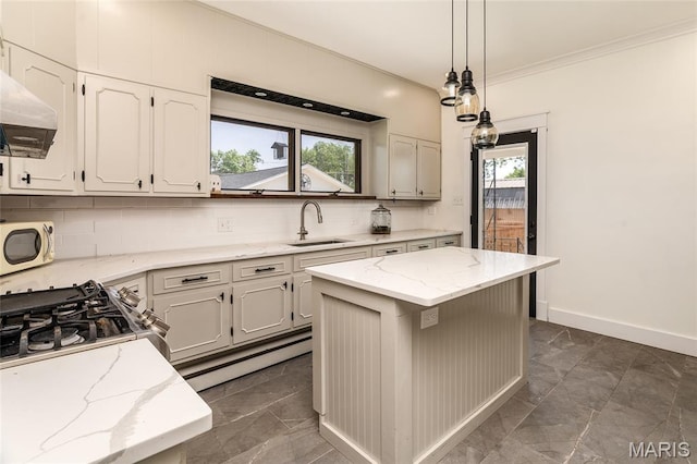 305 W Ray St, Christopher, IL 62822 - kitchen with a sink, white microwave, tasteful backsplash, baseboards, and light stone counters