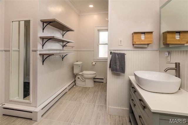 305 W Ray St, Christopher, IL 62822 - bathroom with baseboard heating, a wainscoted wall, toilet, ornamental molding, and vanity