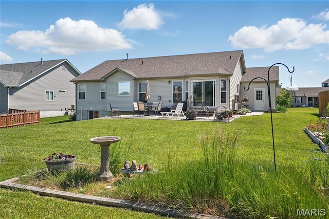 71 Hidden Mill Ct, Moscow Mills, MO 63362 - rear view of house with a patio, a lawn, and roof with shingles