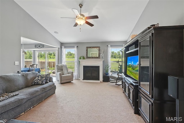 71 Hidden Mill Ct, Moscow Mills, MO 63362 - living room featuring lofted ceiling, carpet flooring, a glass covered fireplace, a ceiling fan, and plenty of natural light