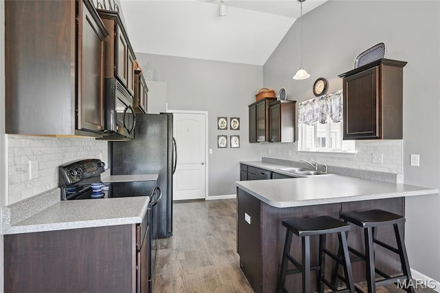 71 Hidden Mill Ct, Moscow Mills, MO 63362 - kitchen with black / electric stove, a sink, decorative backsplash, dark brown cabinetry, and a peninsula