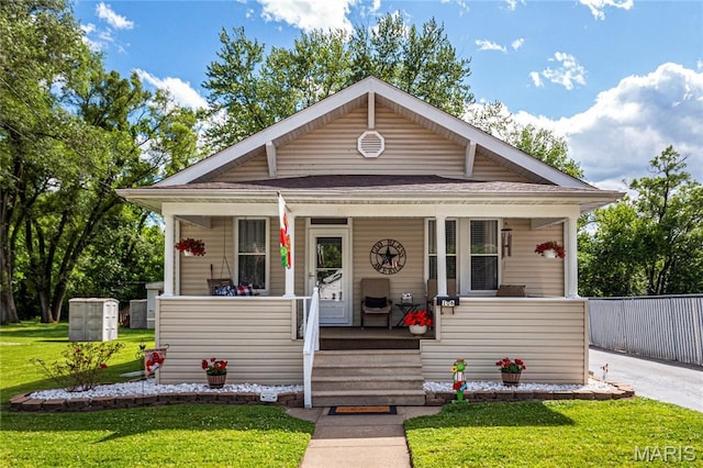 106 E Ofallon Dr, Caseyville, IL 62232 - bungalow with a porch, a front yard, and a shingled roof