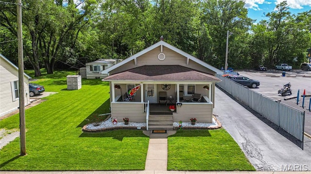 106 E Ofallon Dr, Caseyville, IL 62232 - bungalow-style house featuring a porch, a front yard, and roof with shingles