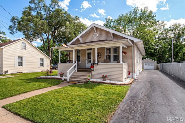 106 E Ofallon Dr, Caseyville, IL 62232 - bungalow-style house featuring a porch, a garage, an outdoor structure, driveway, and a front yard
