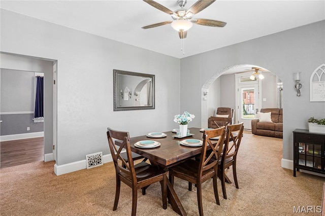 106 E Ofallon Dr, Caseyville, IL 62232 - dining room with ceiling fan, arched walkways, light carpet, and baseboards
