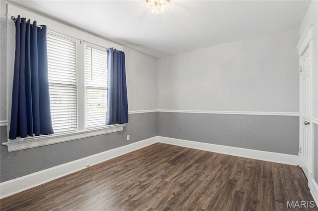 106 E Ofallon Dr, Caseyville, IL 62232 - empty room featuring plenty of natural light, wood finished floors, baseboards, and a textured wall