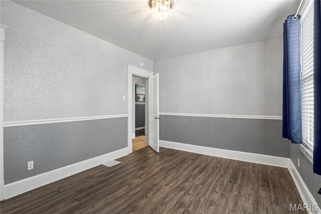 106 E Ofallon Dr, Caseyville, IL 62232 - spare room featuring a textured wall, wood finished floors, and baseboards