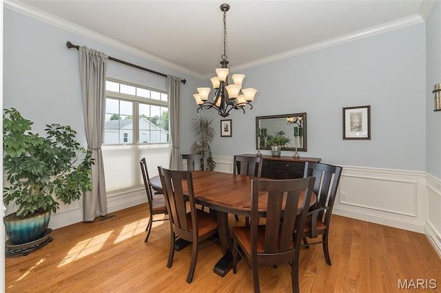 1804 Sterling Oaks Dr, Saint Peters, MO 63376 - dining space featuring a chandelier, crown molding, light wood finished floors, and wainscoting