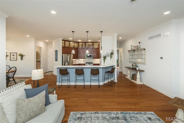 1804 Sterling Oaks Dr, Saint Peters, MO 63376 - kitchen with stainless steel appliances, recessed lighting, a kitchen breakfast bar, baseboards, and a peninsula