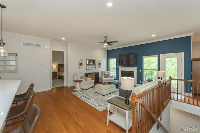 1804 Sterling Oaks Dr, Saint Peters, MO 63376 - living area with a fireplace, ceiling fan, crown molding, recessed lighting, and wood finished floors