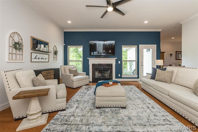 1804 Sterling Oaks Dr, Saint Peters, MO 63376 - living room with crown molding, ceiling fan, a glass covered fireplace, recessed lighting, and wood finished floors