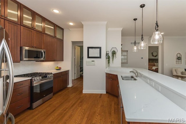 1804 Sterling Oaks Dr, Saint Peters, MO 63376 - kitchen with appliances with stainless steel finishes, a sink, crown molding, a peninsula, and light countertops