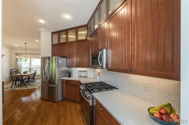 1804 Sterling Oaks Dr, Saint Peters, MO 63376 - kitchen featuring appliances with stainless steel finishes, backsplash, light countertops, recessed lighting, and hanging light fixtures