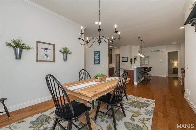 1804 Sterling Oaks Dr, Saint Peters, MO 63376 - dining area featuring a chandelier, dark wood finished floors, baseboards, ornamental molding, and recessed lighting