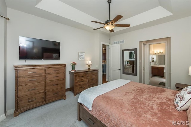 1804 Sterling Oaks Dr, Saint Peters, MO 63376 - bedroom featuring light carpet, a tray ceiling, ensuite bathroom, baseboards, and ceiling fan