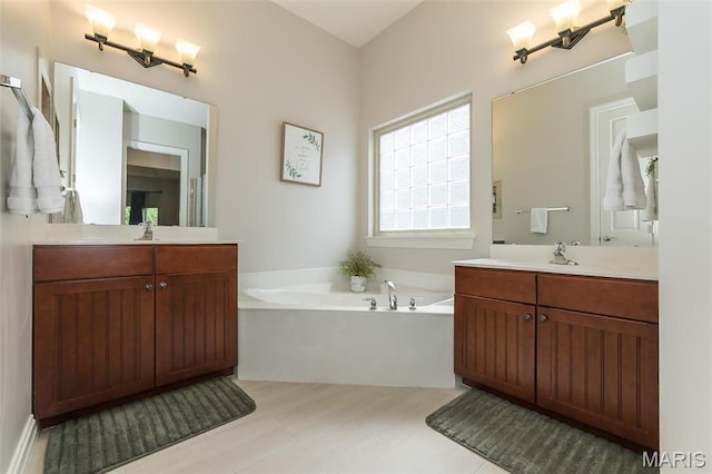 1804 Sterling Oaks Dr, Saint Peters, MO 63376 - bathroom with a bath and two vanities