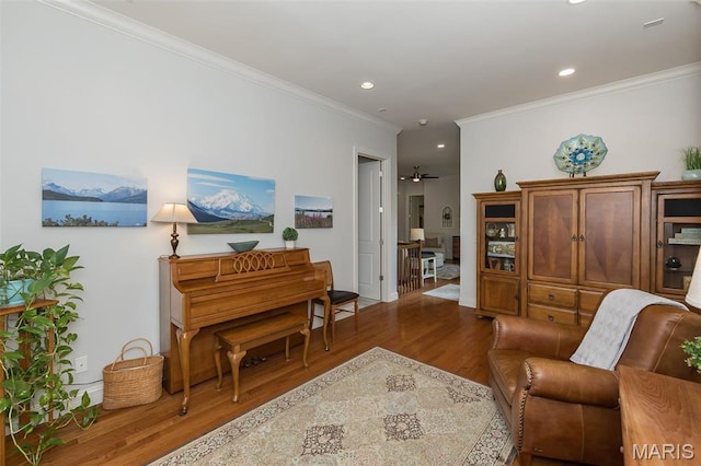 1804 Sterling Oaks Dr, Saint Peters, MO 63376 - living area with wood finished floors, crown molding, recessed lighting, a ceiling fan, and baseboards