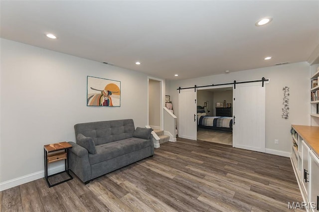 1804 Sterling Oaks Dr, Saint Peters, MO 63376 - living room with a barn door, dark wood-type flooring, recessed lighting, and baseboards