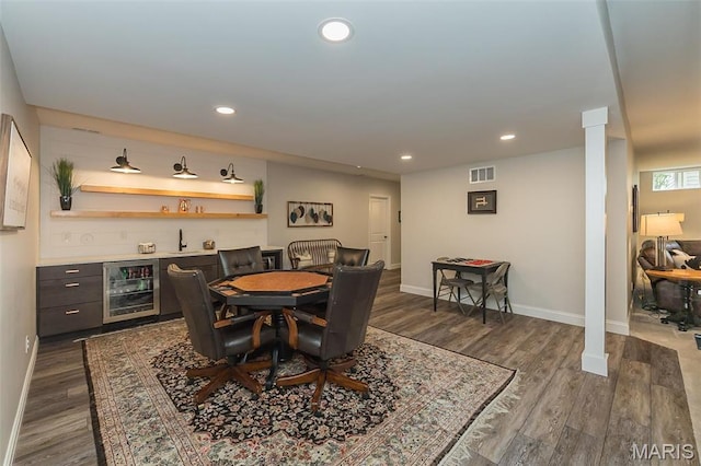 1804 Sterling Oaks Dr, Saint Peters, MO 63376 - dining area featuring beverage cooler, a bar, baseboards, dark wood-type flooring, and recessed lighting