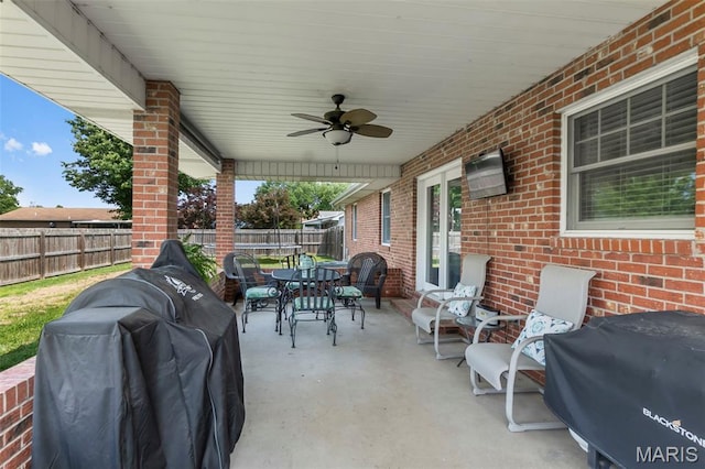 729 Euclid Dr, Sikeston, MO 63801 - view of patio / terrace with outdoor dining area, a fenced backyard, french doors, ceiling fan, and a grill