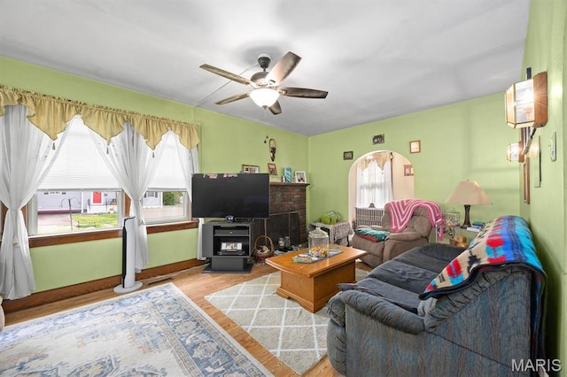 living area featuring a ceiling fan and wood finished floors